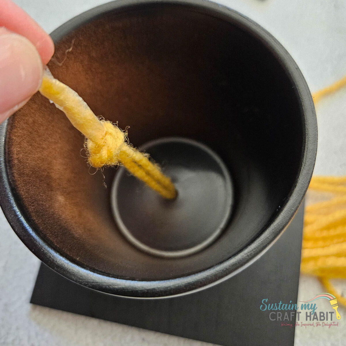 Tying a knot onto tassel.