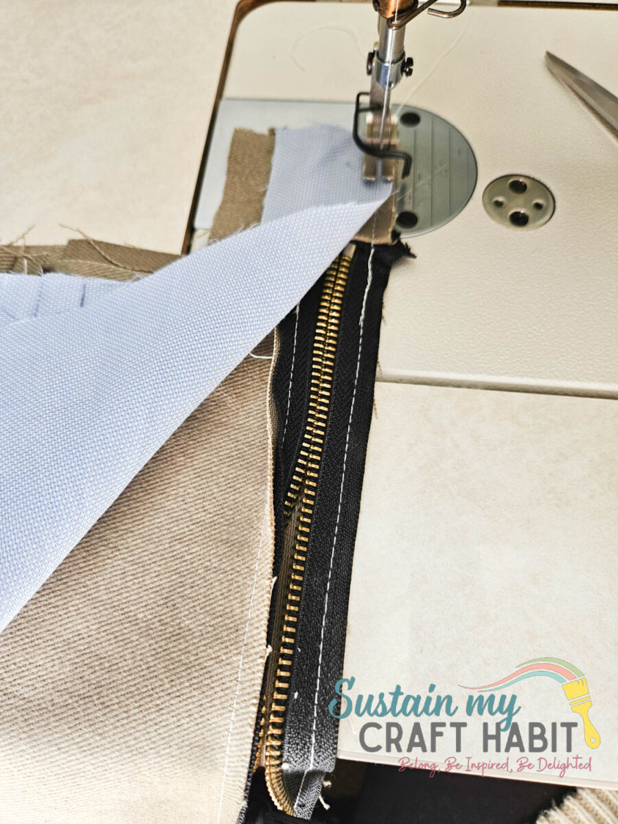 Aligning fabric to zipper piece.