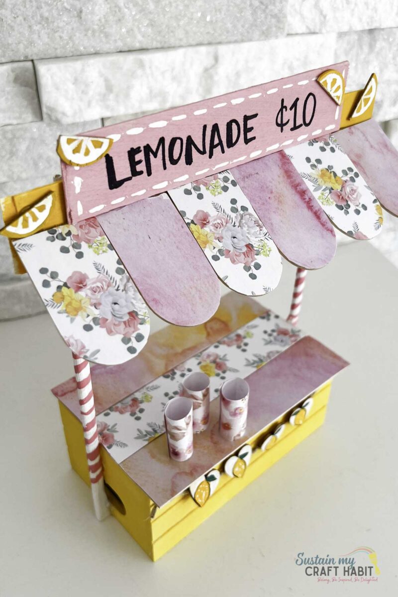 Over head view of a mini lemonade stand made with dollar tree materials.