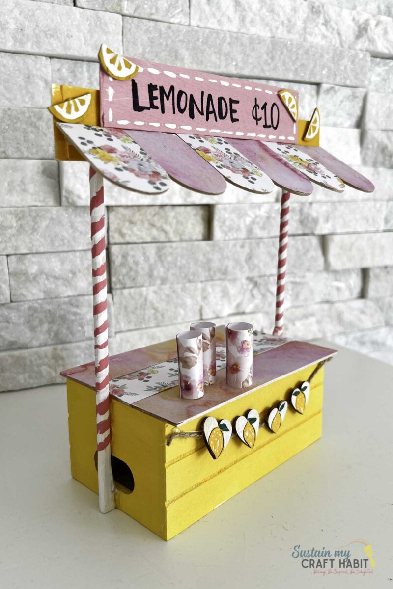 Mini lemonade stand made with dollar tree materials.