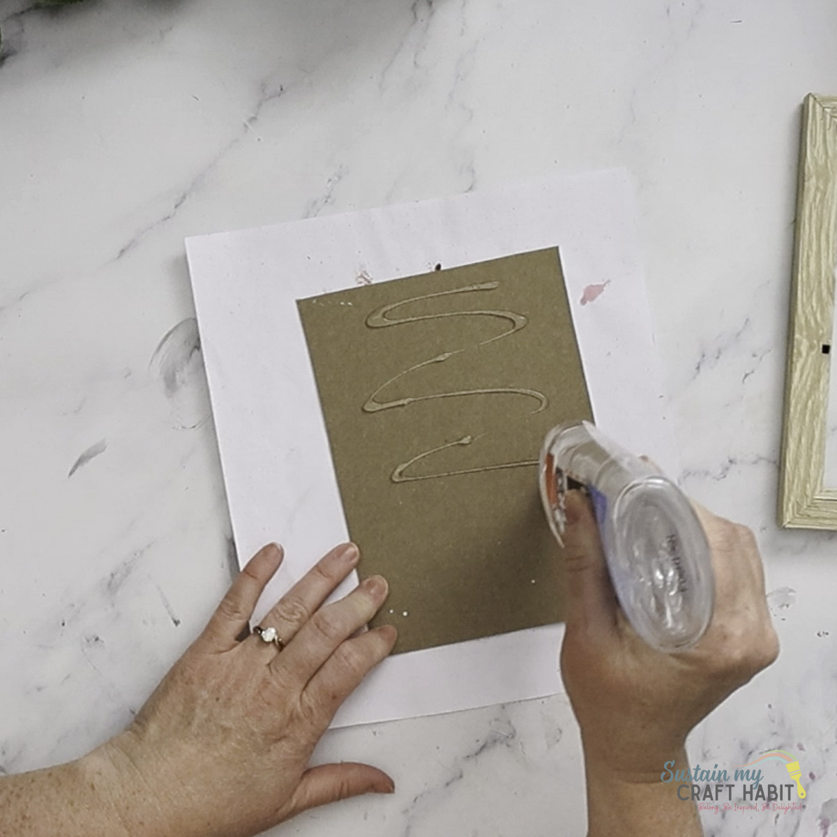 Adding glue to paper backing.