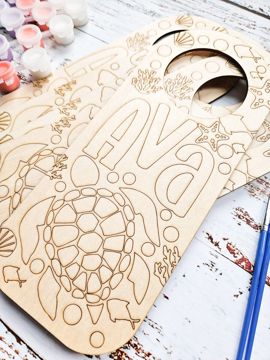 Close up of engraved wood door hangers.
