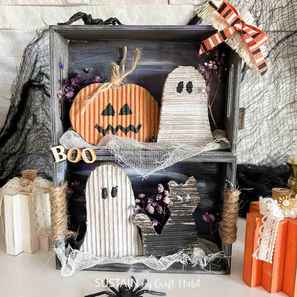 Upcycled cardboard Halloween craft made with festive characters inside a box.