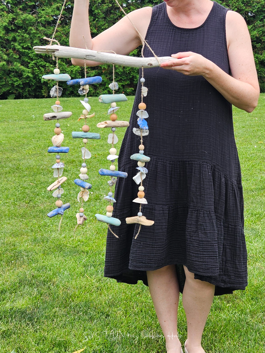 Woman holding a silent coastal wind chime.