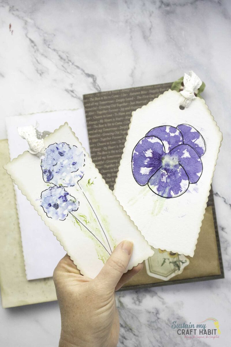 Hand holding flower print scrap paper.
